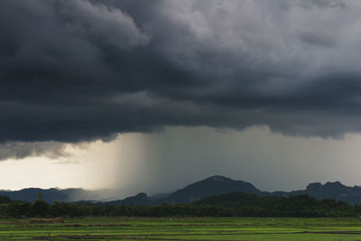 Scenic view of storm clouds over landscape