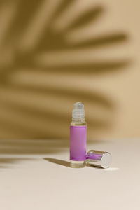 Close-up of perfume on colored background