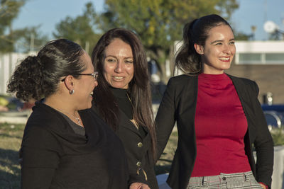 Portrait of a smiling young woman standing outdoors