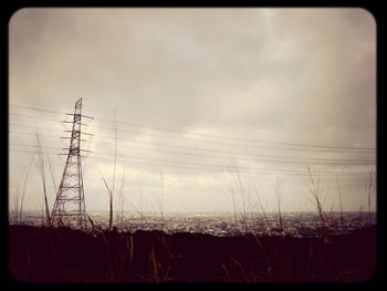 Low angle view of electricity pylon against sky