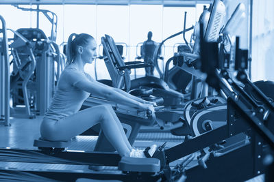 Low section of woman exercising in gym