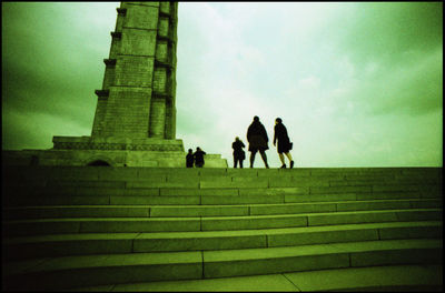 Low angle view of people against sky