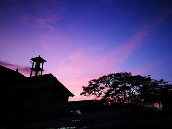 Low angle view of silhouette trees against sky at sunset