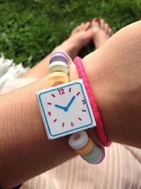 Candy wrist watch in girl's hand