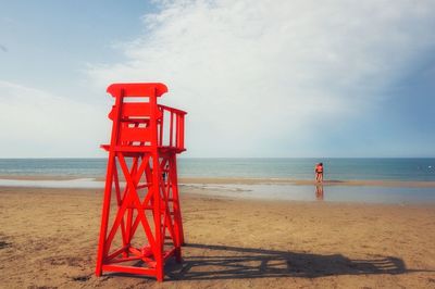 Lifeguard hut on beach against sky