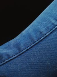 Close-up of blue umbrella against black background