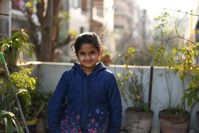 Portrait of smiling boy standing outdoors