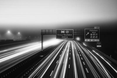 High angle view of light trails on highway at night