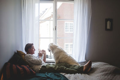 Man sitting by window at home