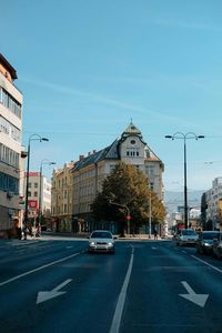 Cars on street against sky