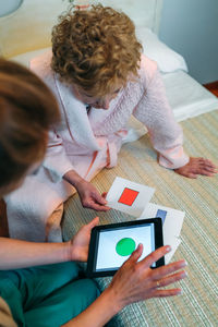 Nurse and senior patient using digital tablet in hospital