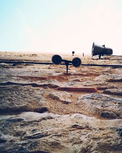 Scenic view of sand on beach against sky