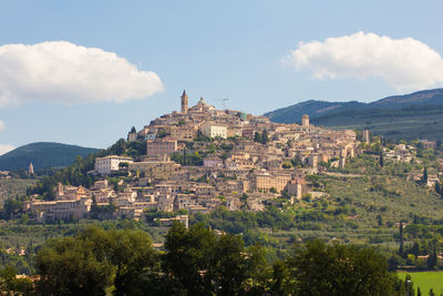 View of trevi medieval town against cloudy sky