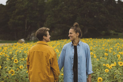 Couple on flowering sunflower field