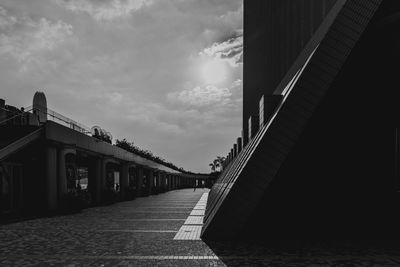 Bridge over canal amidst buildings against sky