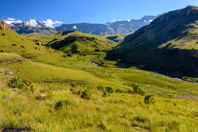 Scenic view of landscape and mountains against sky