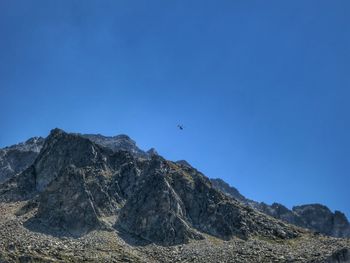 Low angle view of mountain against clear blue sky