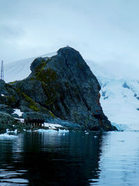 Two people standing on peak in antarctica