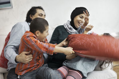 Playful muslim family in living room