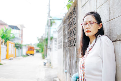 Portrait of young woman standing outdoors