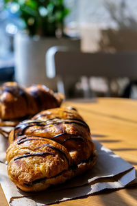 Fresh and tasty croissants with chocolate butter and banana on crumpled paper. breakfast at cafe.