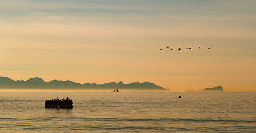 Scenic view of sea at sunset