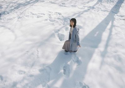 High angle view of girl on snow field