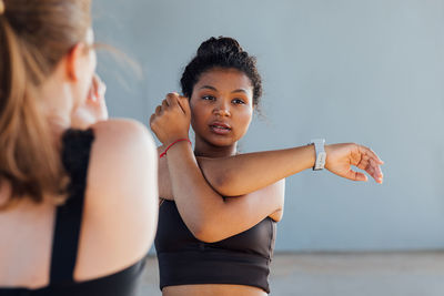 Portrait of young woman exercising at gym