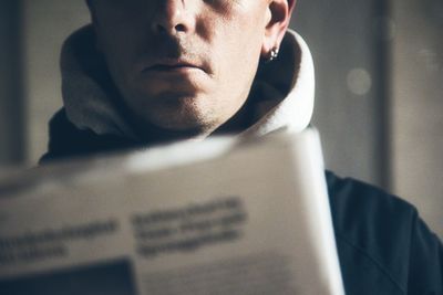 Adult man reading the newspaper