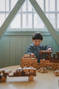 Side view of boy playing chess