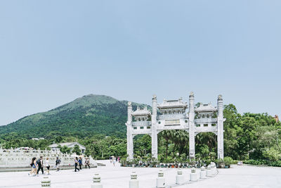 Group of people in front of built structure against sky