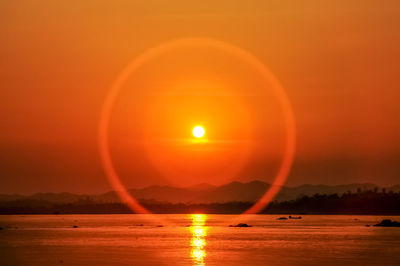 Scenic view of sea against orange sky