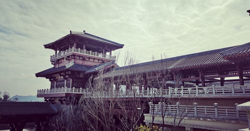 Bridge over river against buildings in city