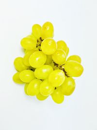 Close-up of grapes over white background