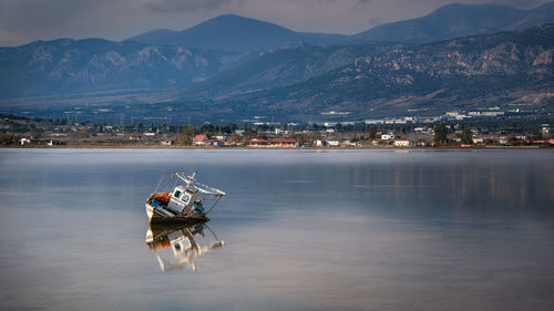 Abandoned boat aground, boat in sea