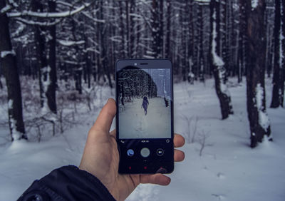 Person standing on snow covered landscape