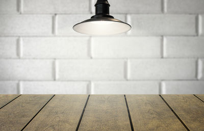 Close-up of illuminated lamp on wall at home