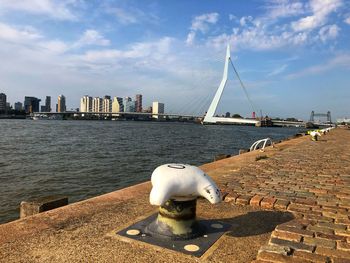 Sea by buildings against sky