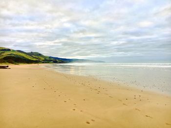 Scenic view of beach against sky