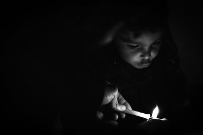 Cute little boy is carefully watching the fire