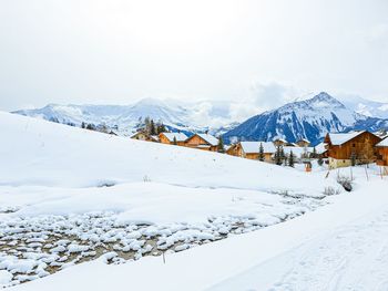 Scenic view of snow covered mountains against sky