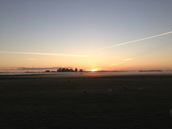 View of sunset over field