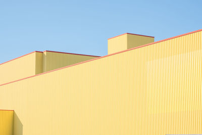 Low angle view of factory against clear sky