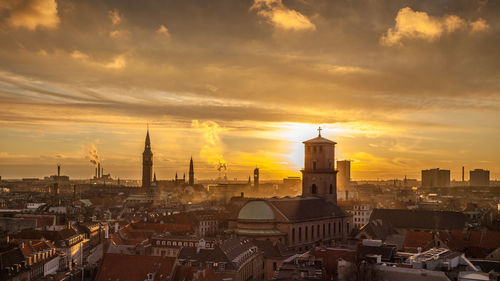 Panorama with sunset over copenhagen cityscape. romantic atmosphere. urban. clouds. sundown. towers.