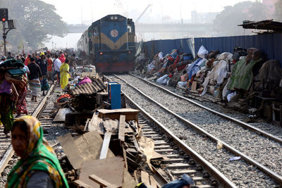 Group of people waiting train at railroad station platform