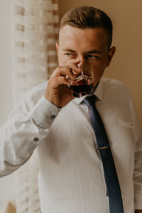 Midsection of woman drinking glass