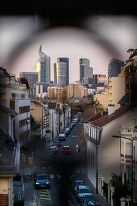 Traffic on road amidst buildings in city