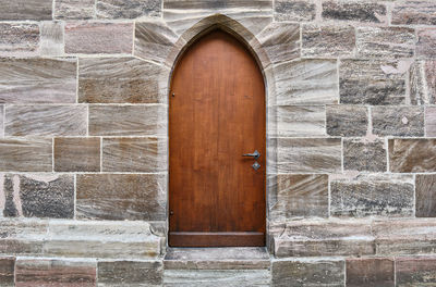 Closed wooden door on wall