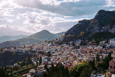 Townscape by mountains against sky