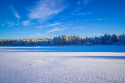 Scenic view of frozen lake against sky during winter